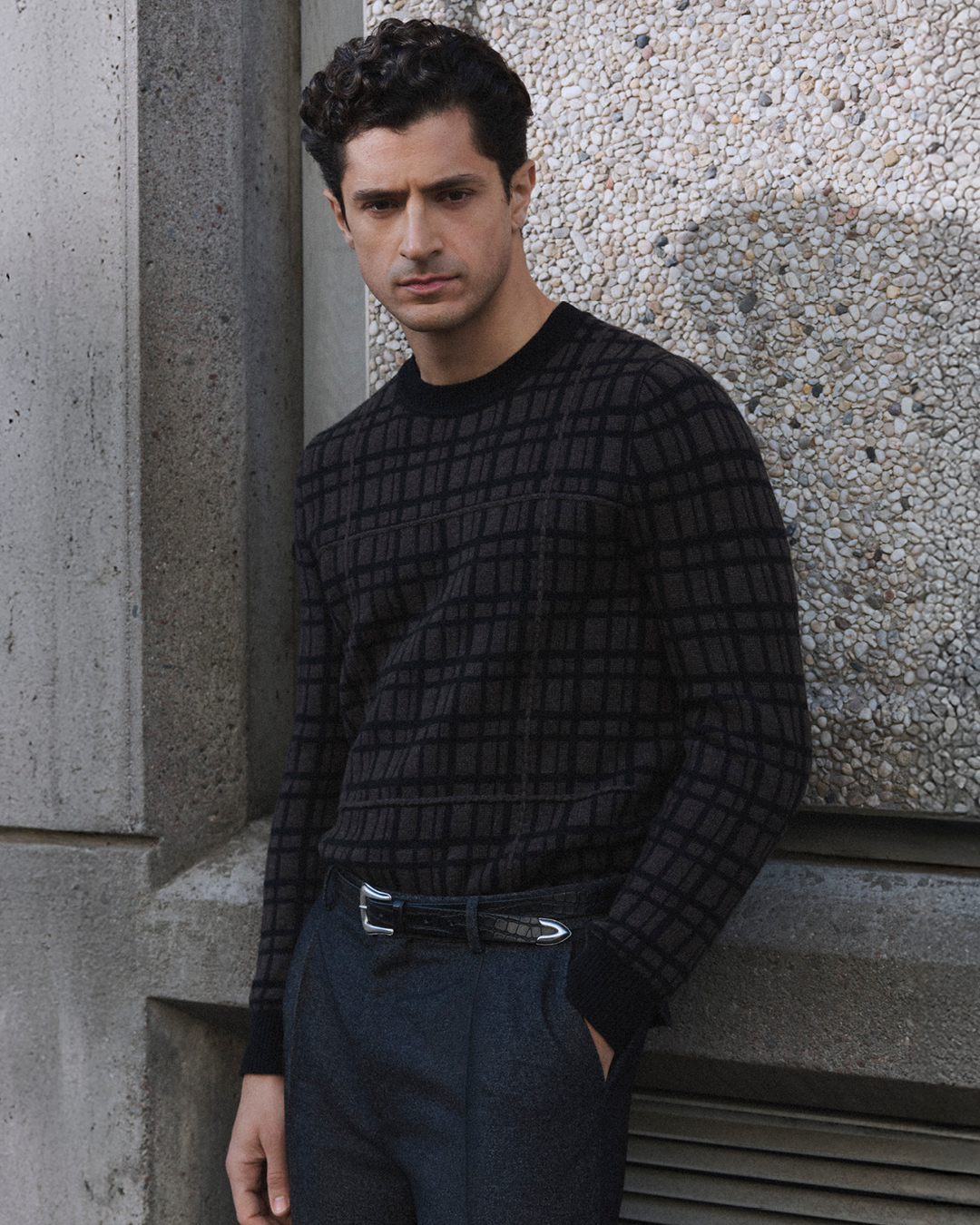 man in trousers and knitwear