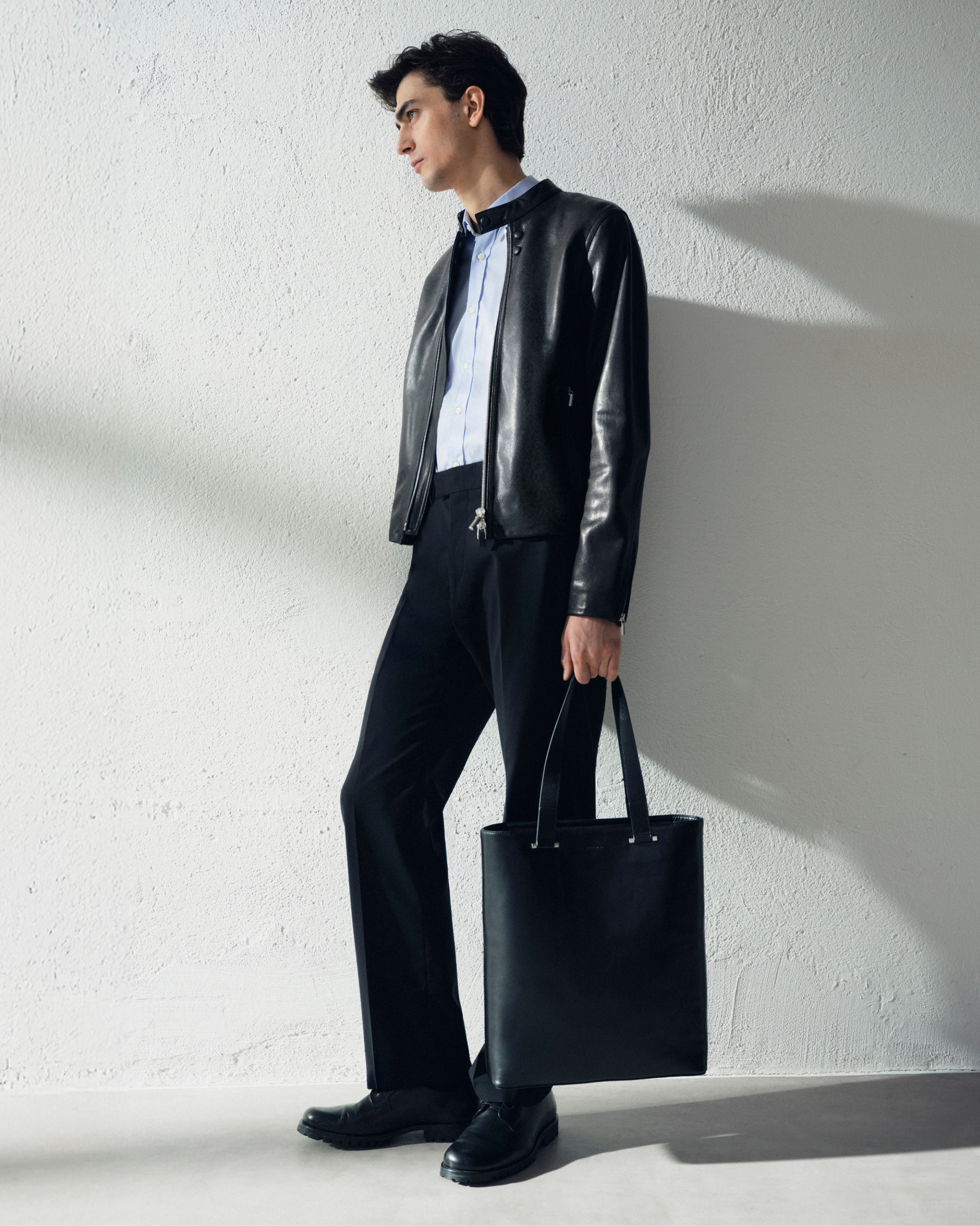 Man in dark trousers and leather jacket