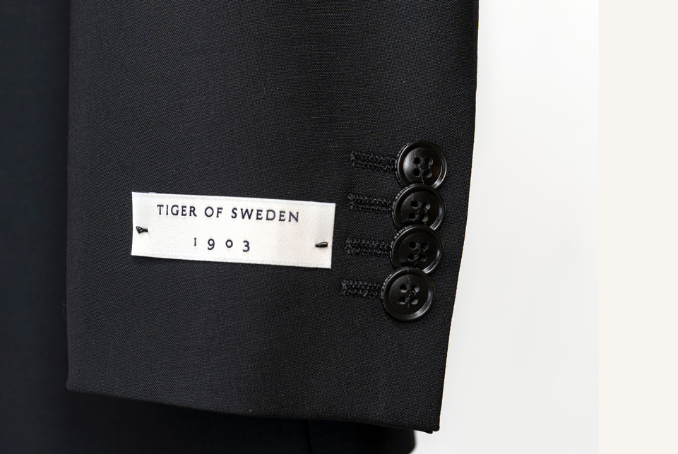 a black suit with a white label on it.