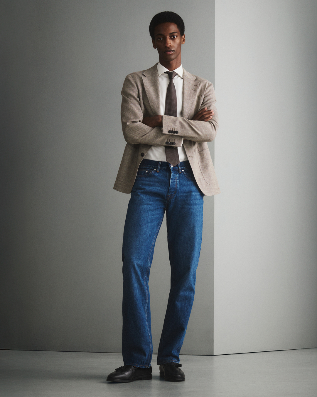 Man in blue denim and beige blazer