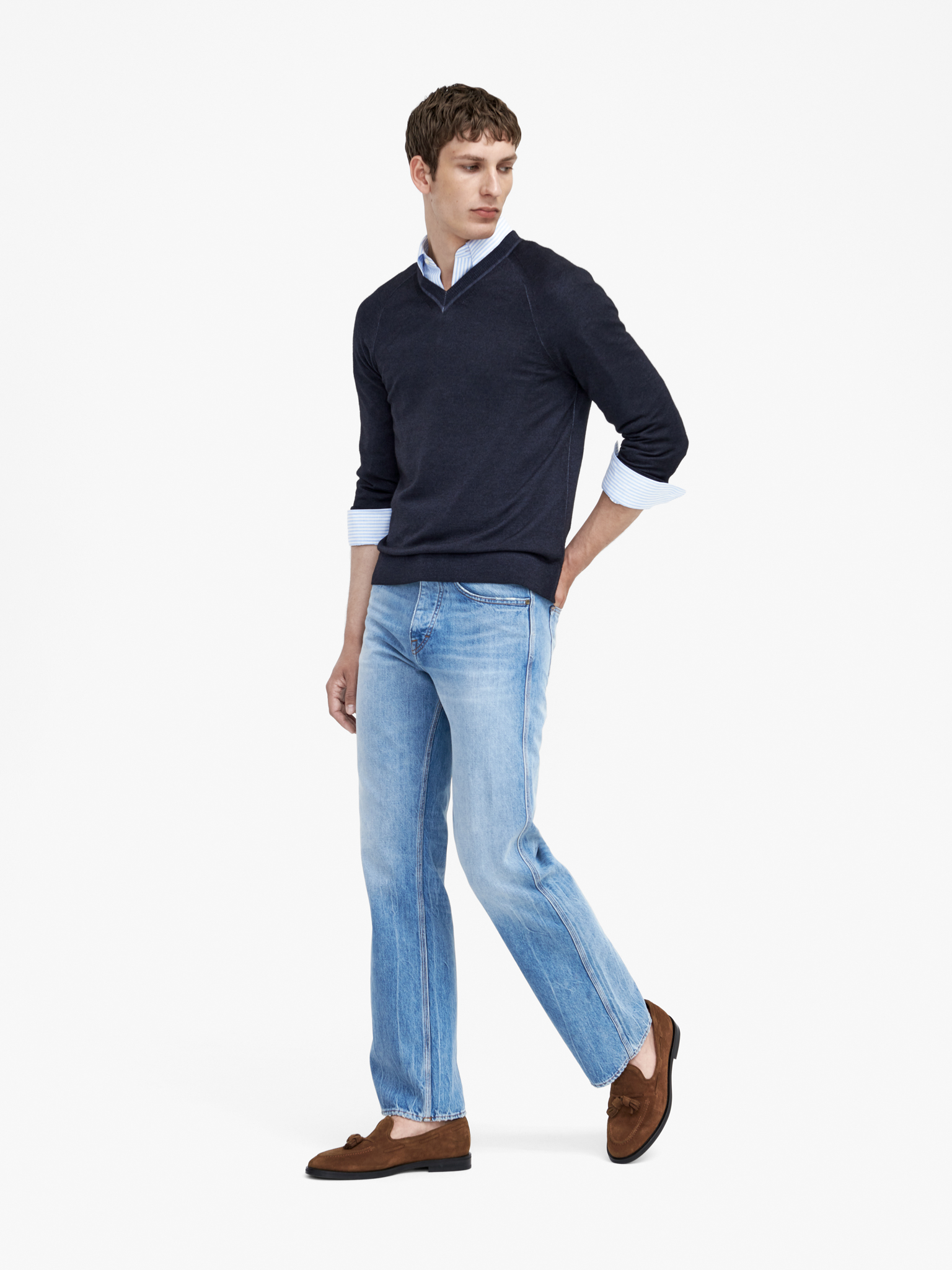 Man in black knit and blue jeans