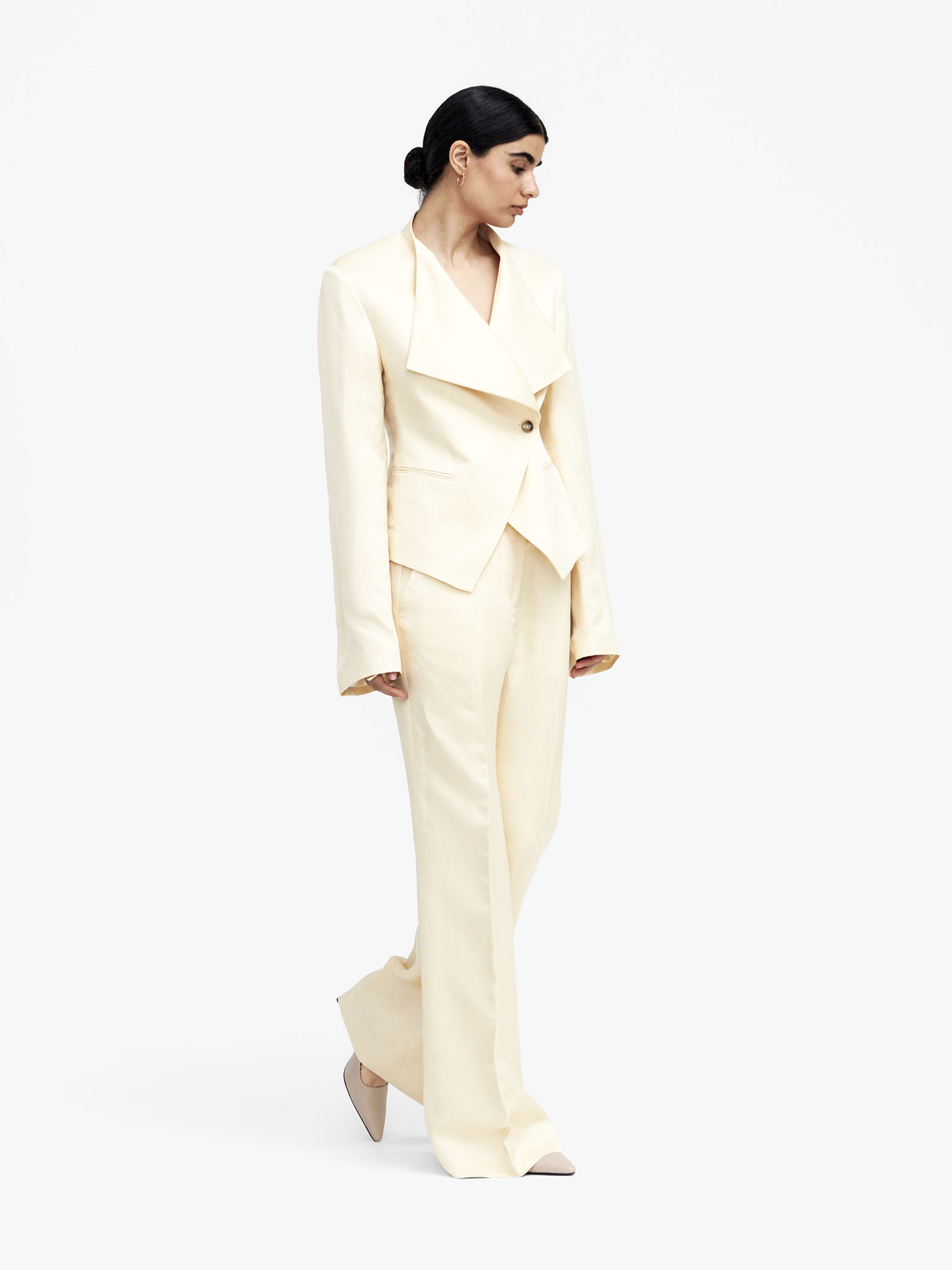 Woman in off white suit