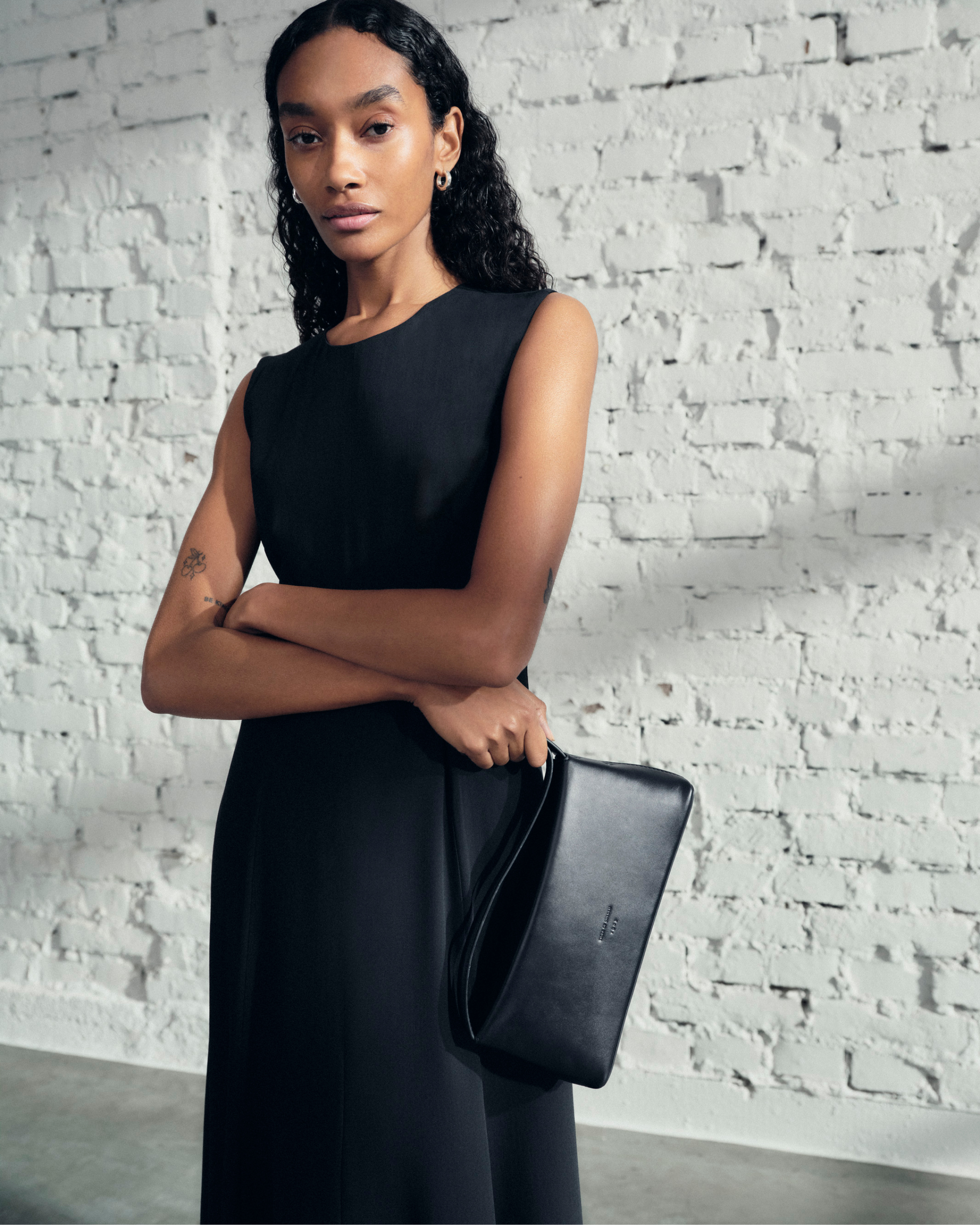 woman in black long dress and bag
