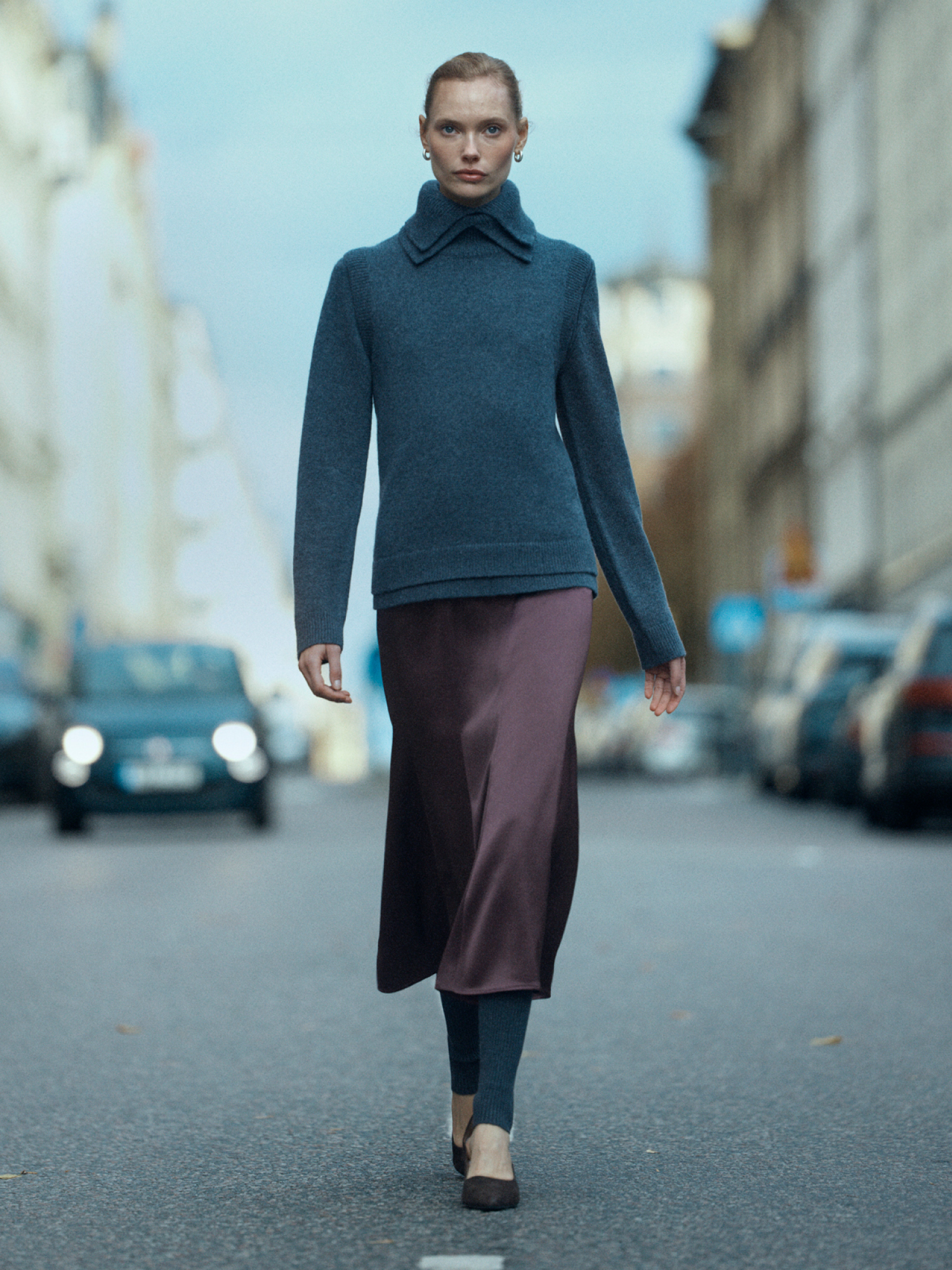 Woman in satin skirt and knit