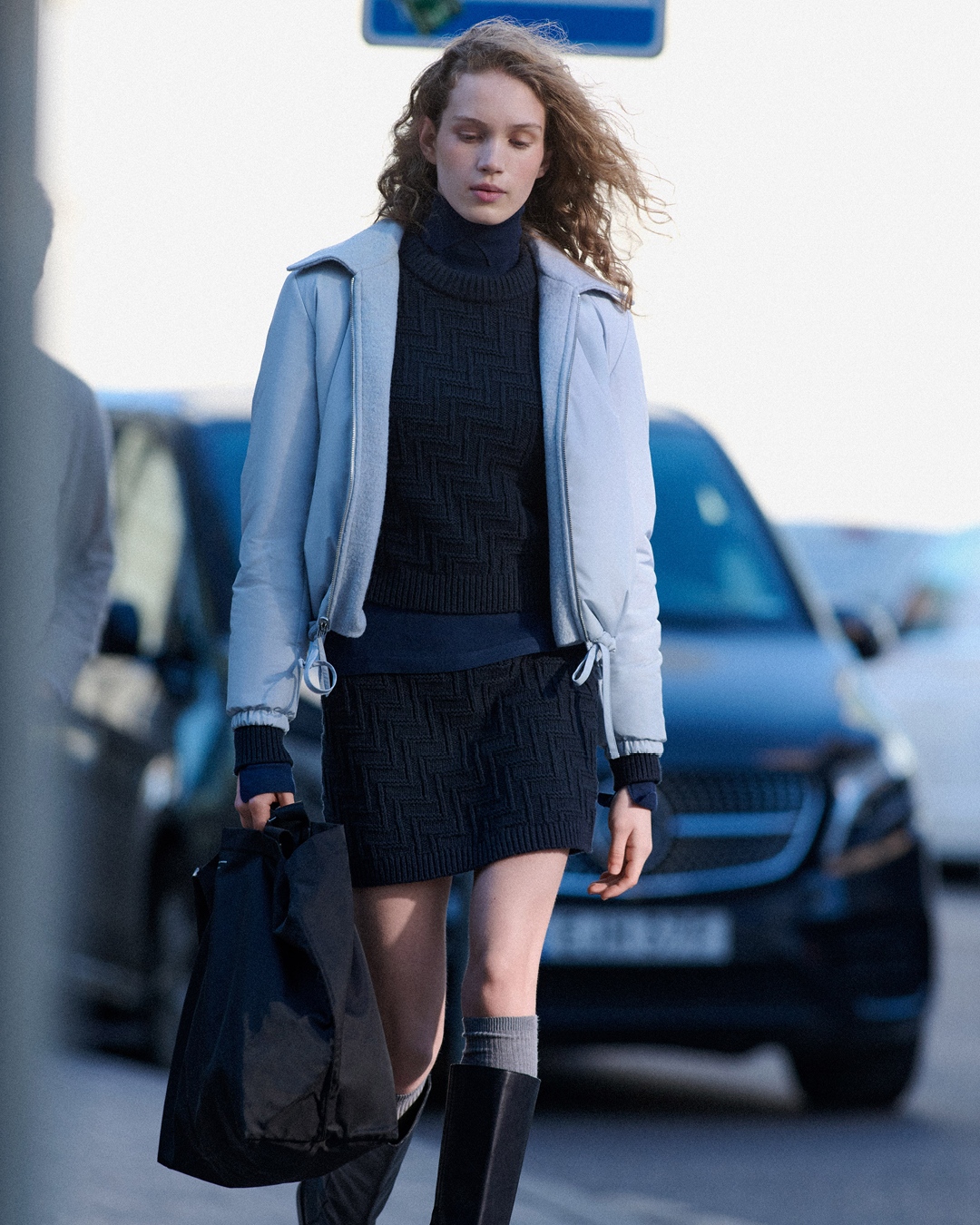 woman in blue puffer and skirt