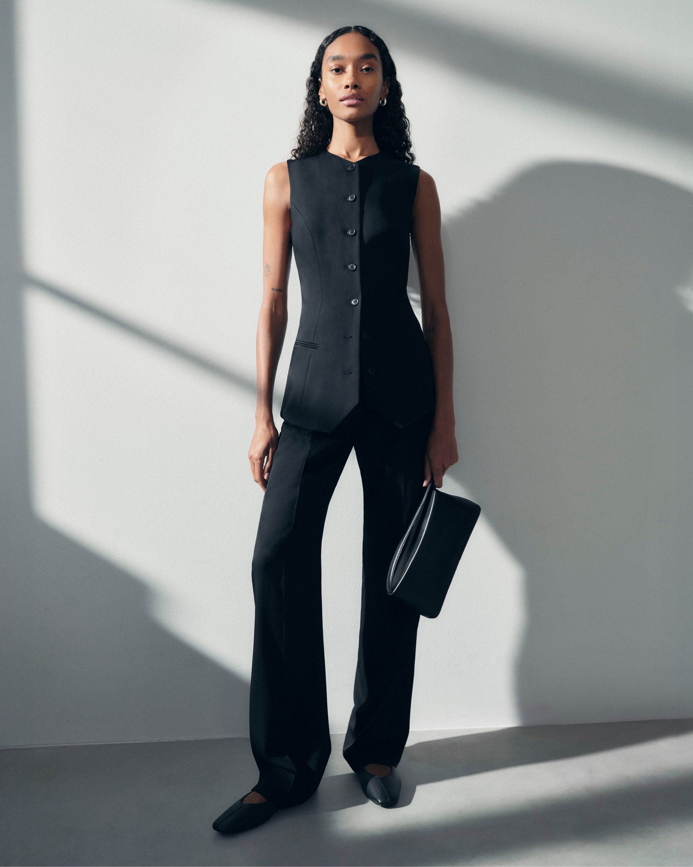 woman in black pants and vest