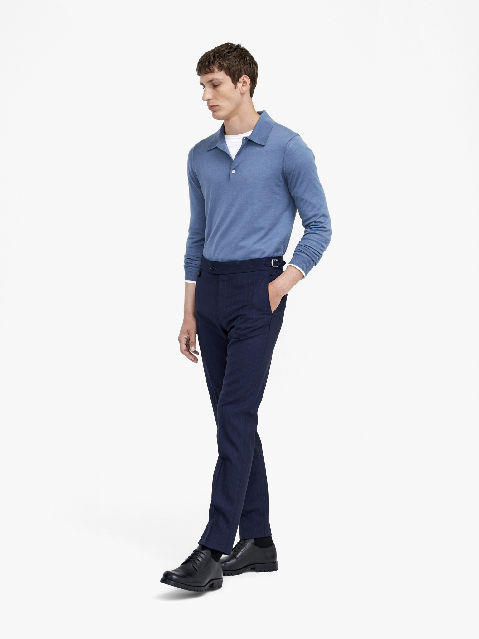 Man in blue polo shirt and navy trousers
