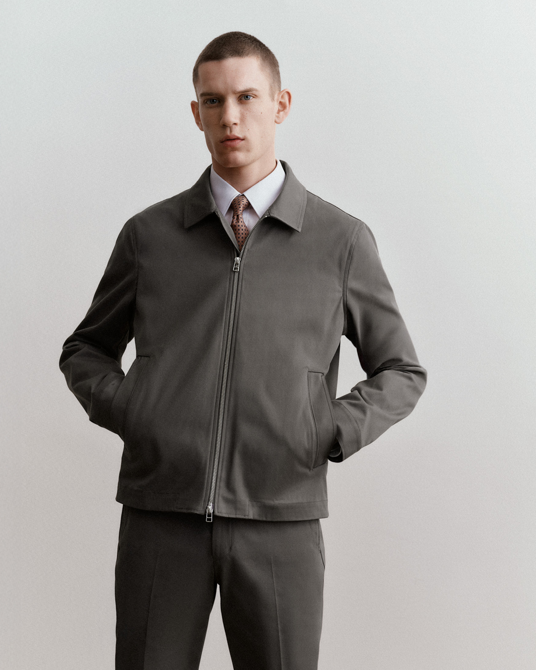 man in grey shirt jacket and chinos