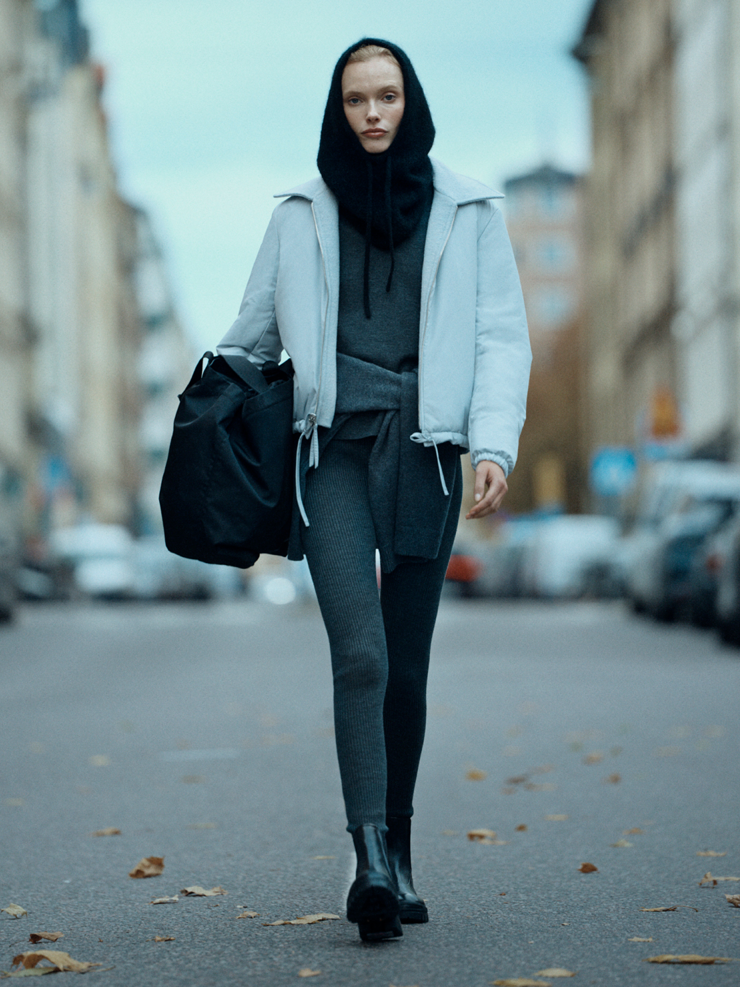 Woman in blue puffer jacket and leggings