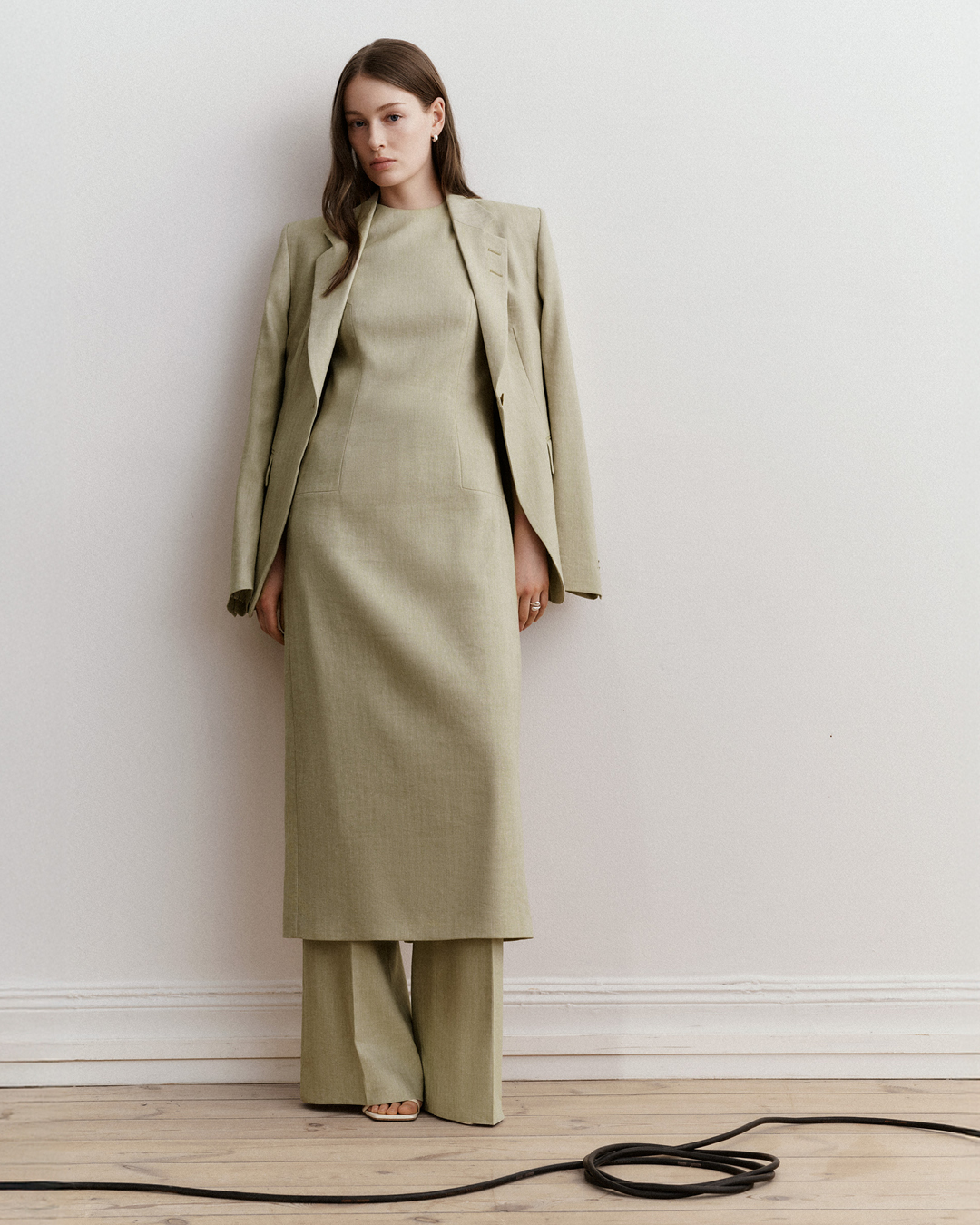 Woman in green dress and suit