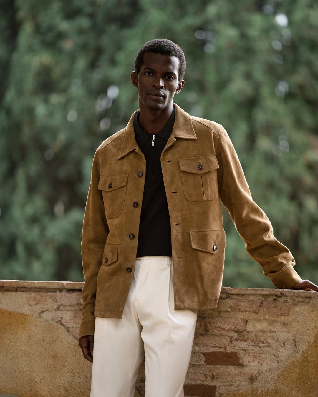 Guy in white pants and suede jacket