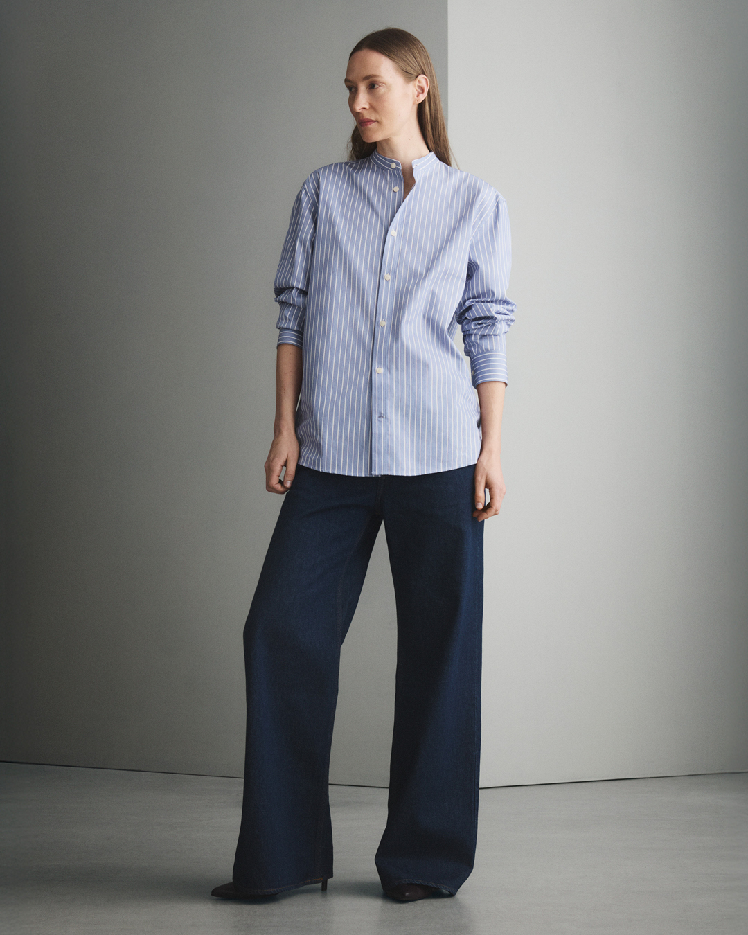 Woman in dark denim and blue shirt