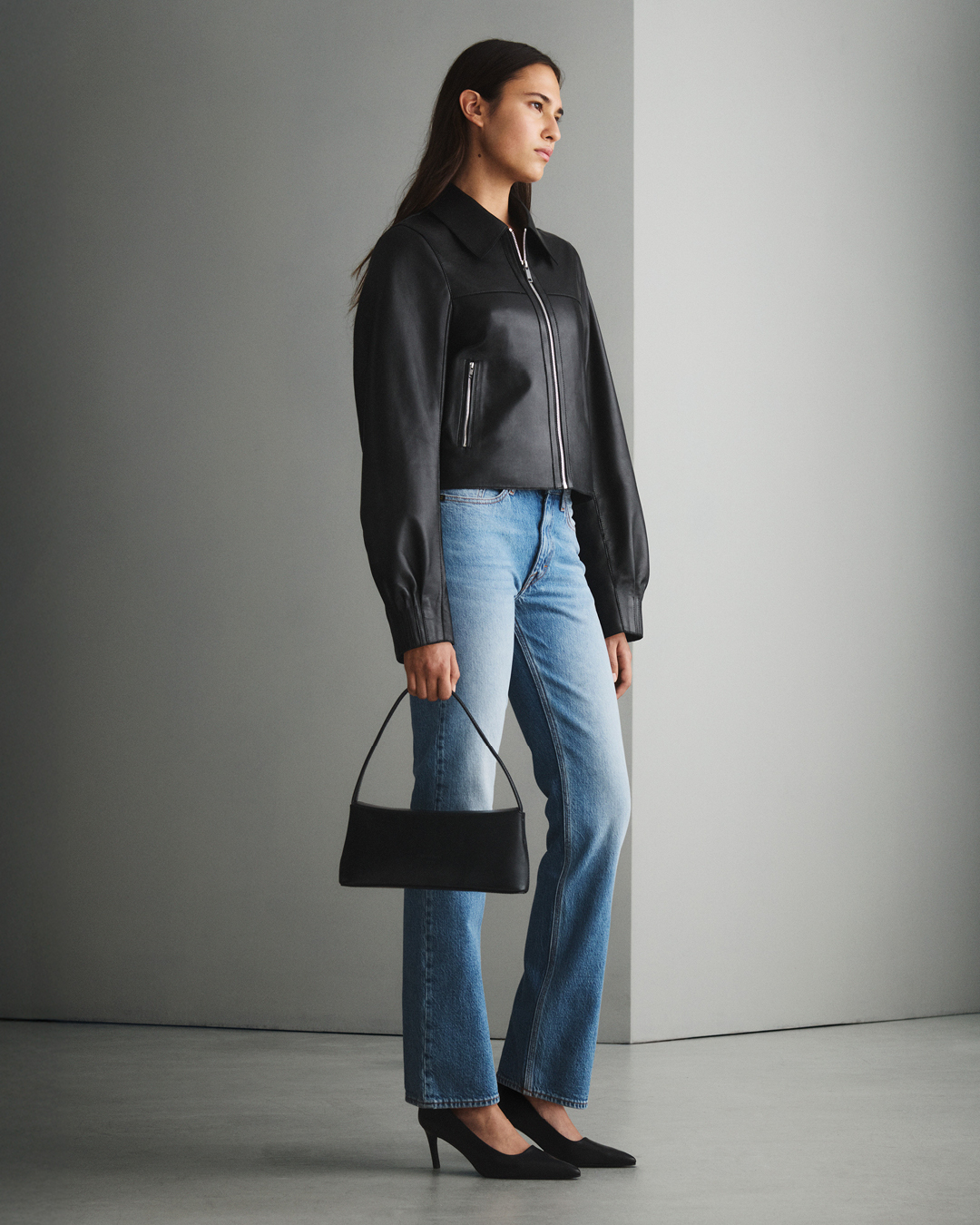 Woman in light blue denim and leather jacket