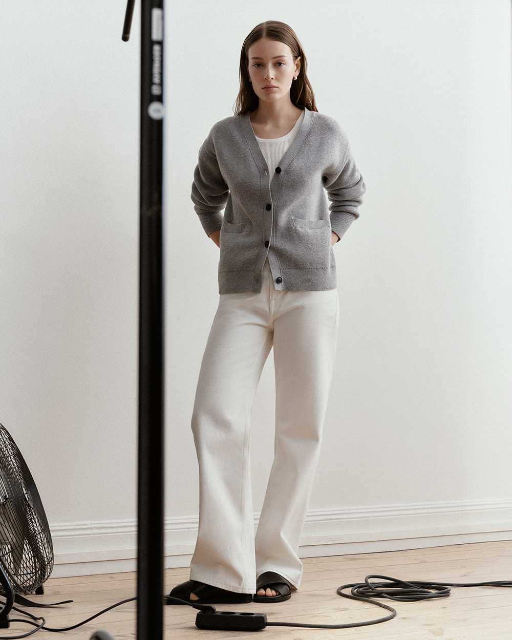 woman in white denim and grey cardigan