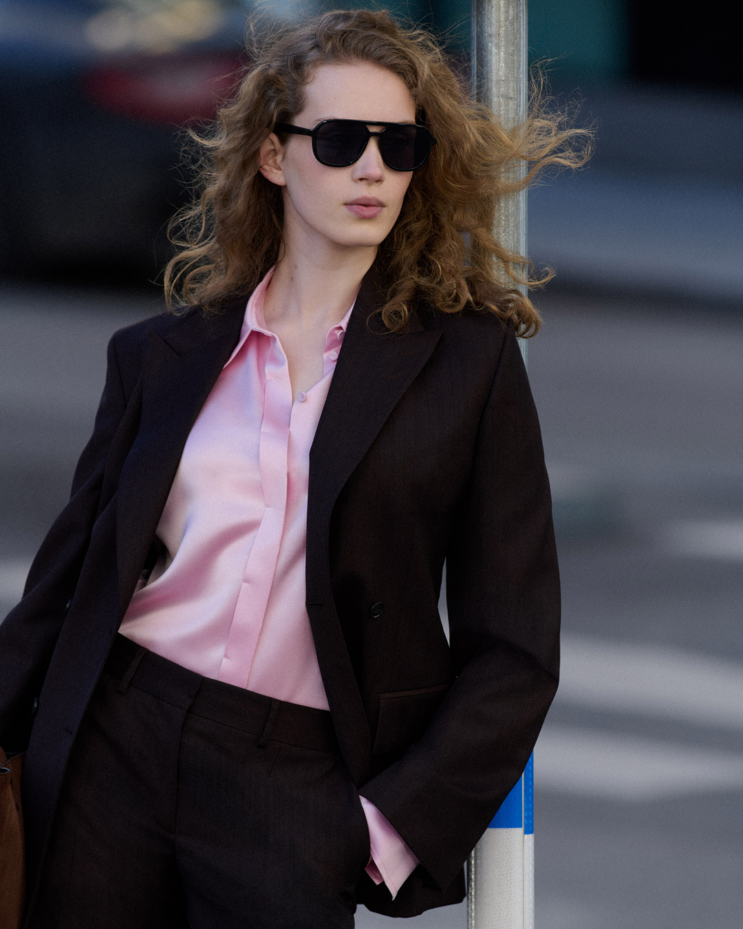 woman in suit and pink satin blouse