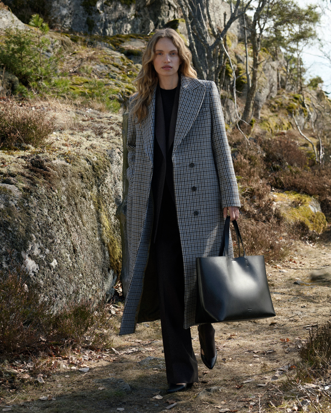 woman in checkered long coat