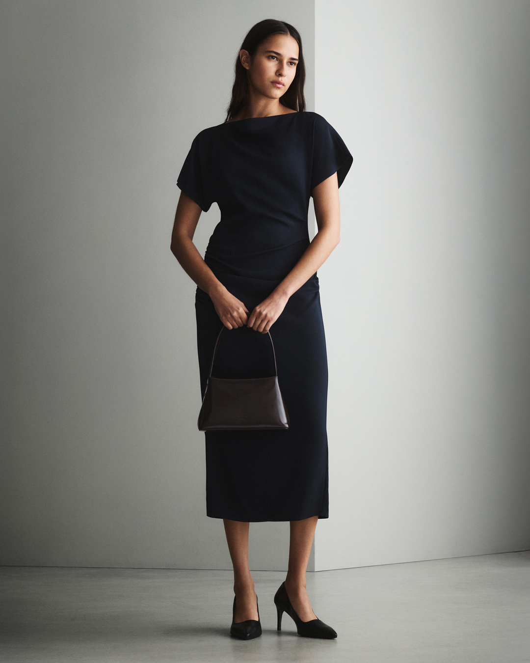 Woman in black dress and bag