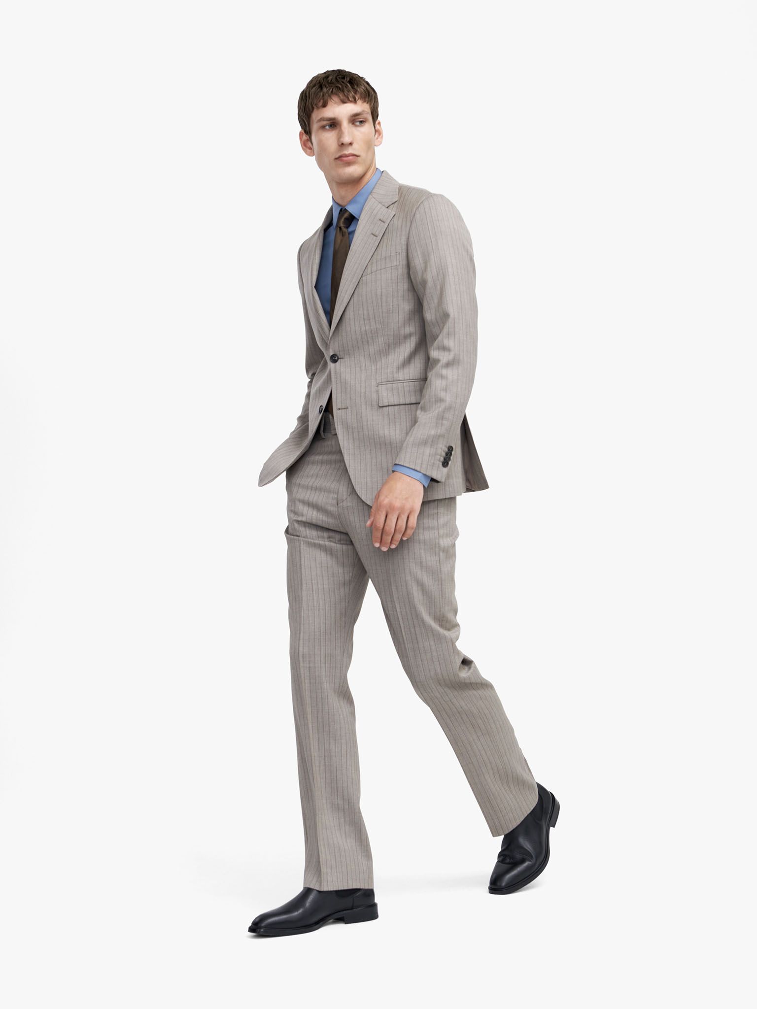 Man in beige pinstriped suit