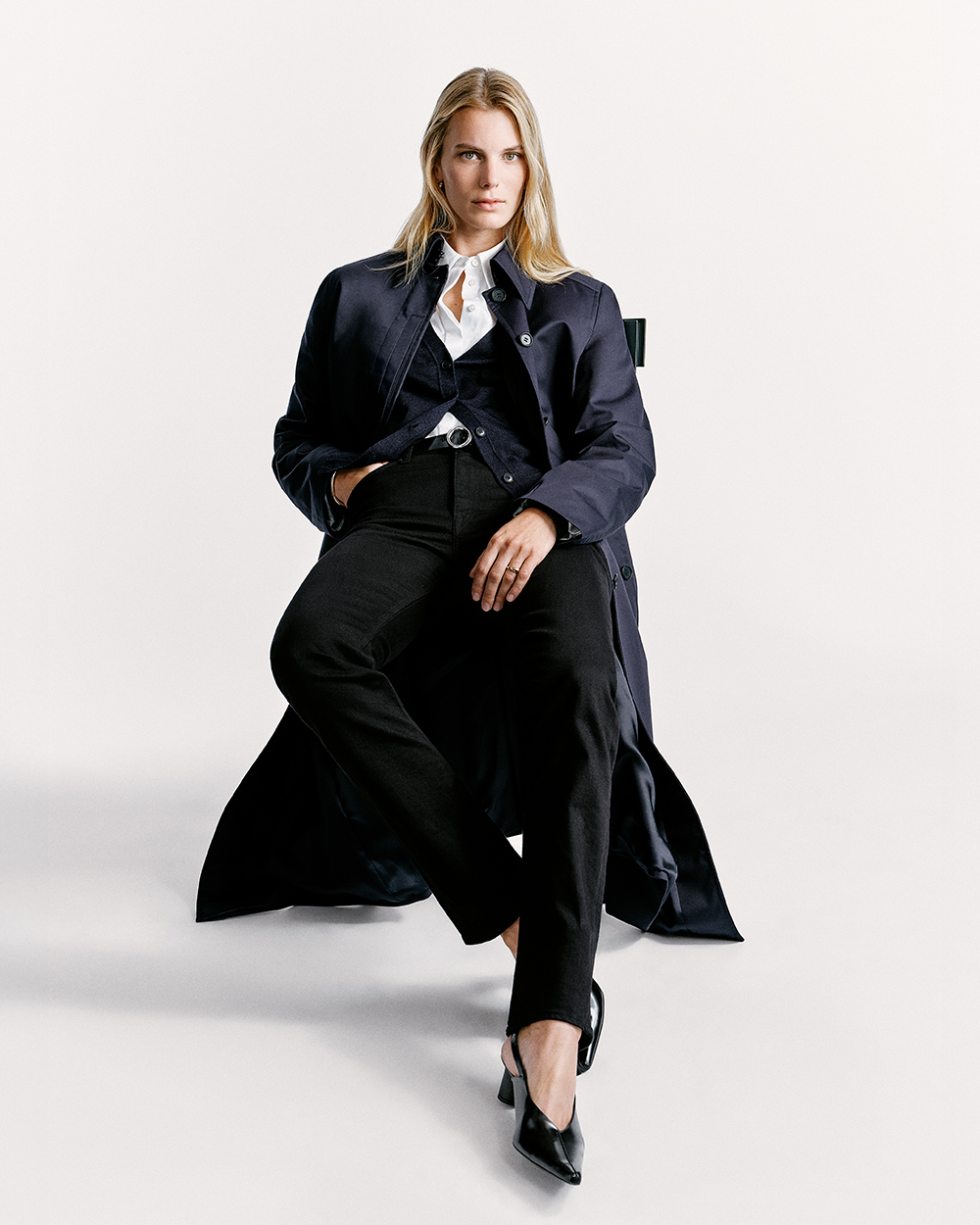 woman in chair in denim and coat