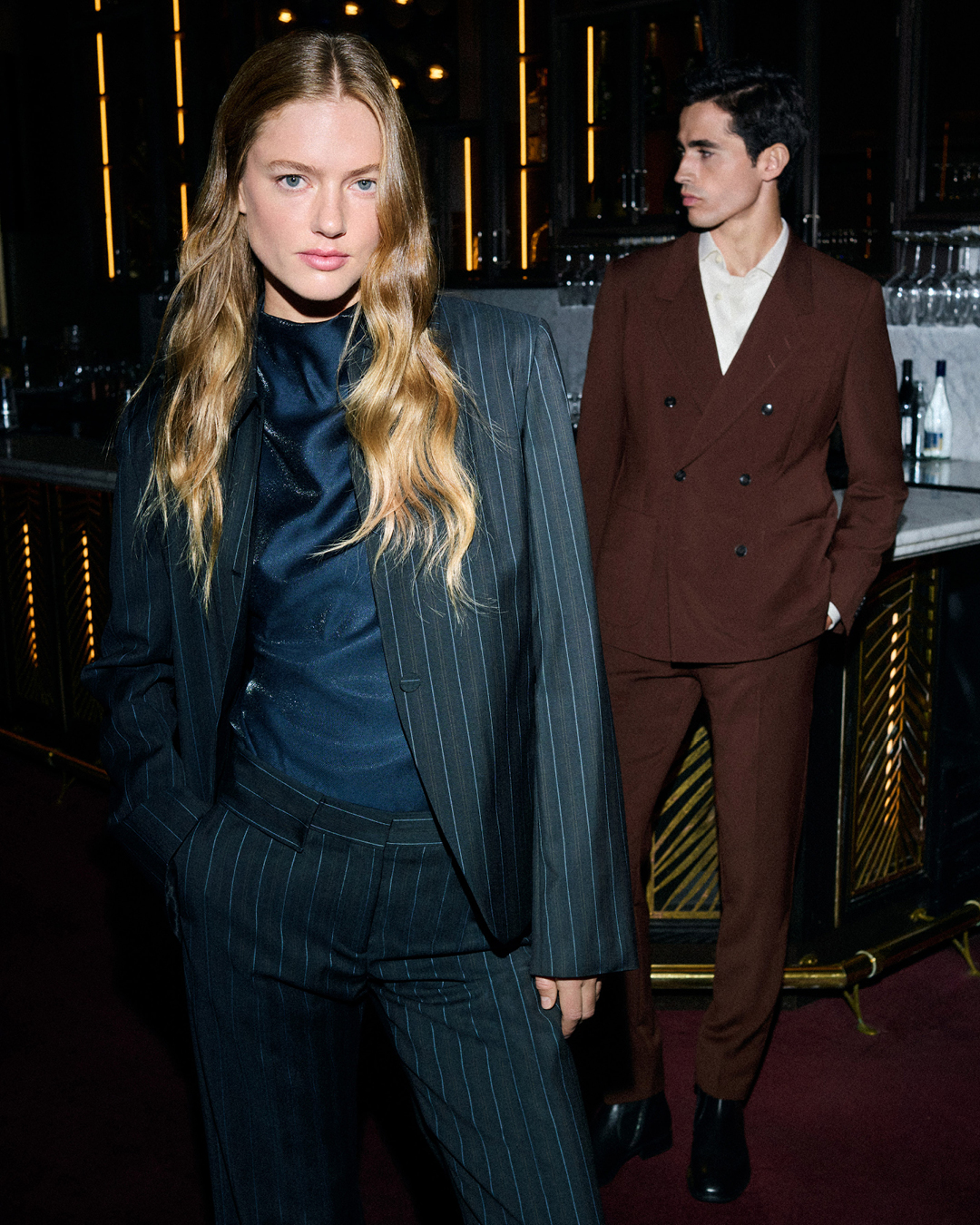woman in striped suit and man in red suit