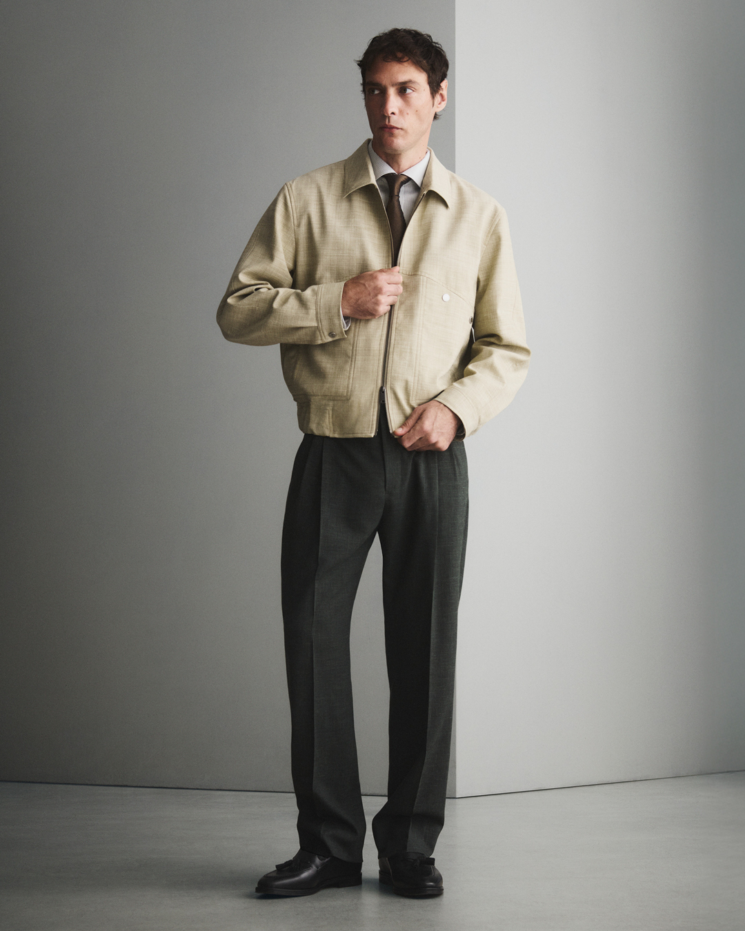 Man in trousers and beige jacket