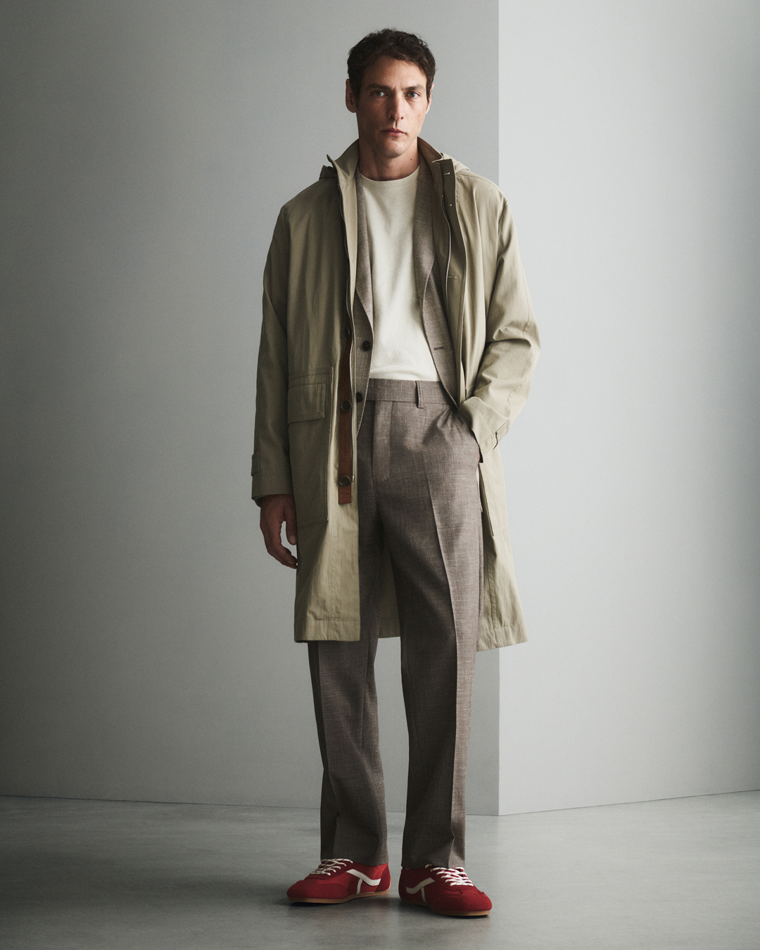 Man in beige trousers and trenchcoat