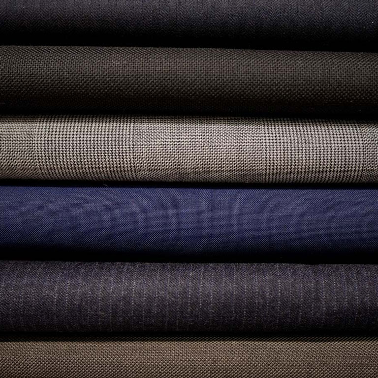 a stack of different colored fabrics.