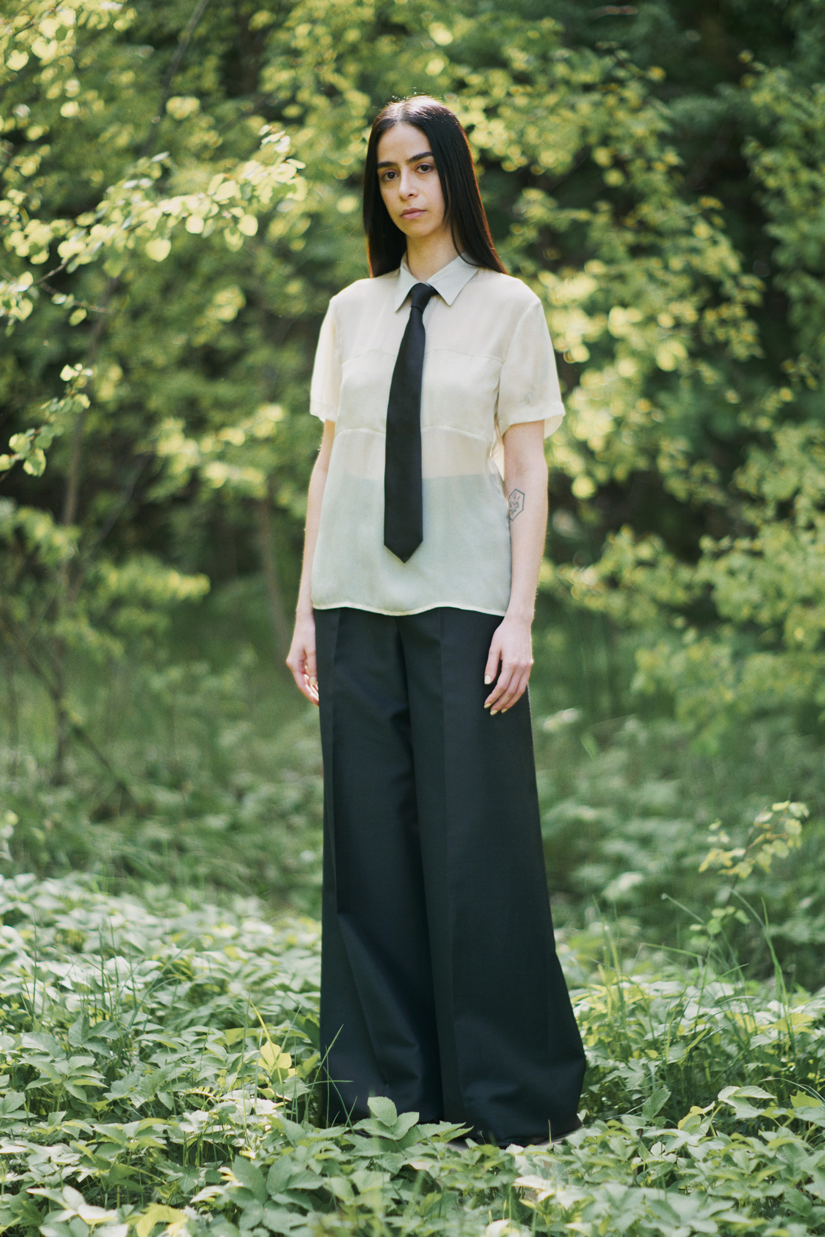 Women in Tiger of Sweden sheer shirt and back trousers