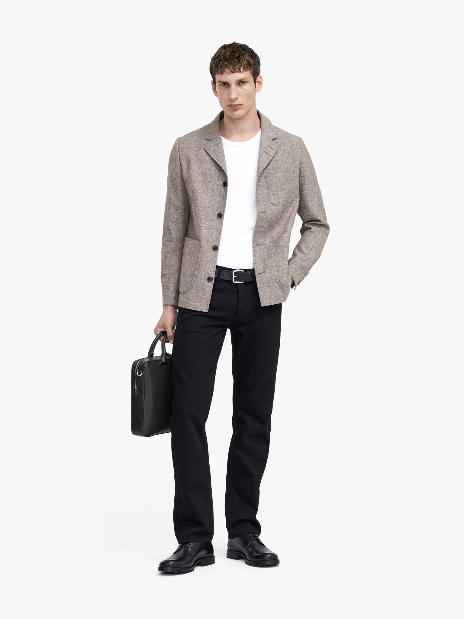 Man in black trousers and beige jacket
