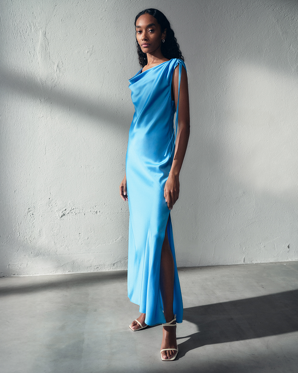 Woman in blue silk dress, dressed for wedding