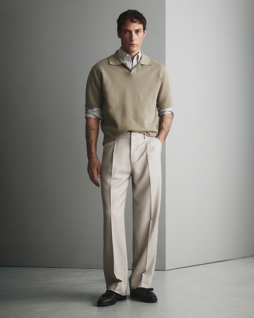 Man in beige trousers and knitwear