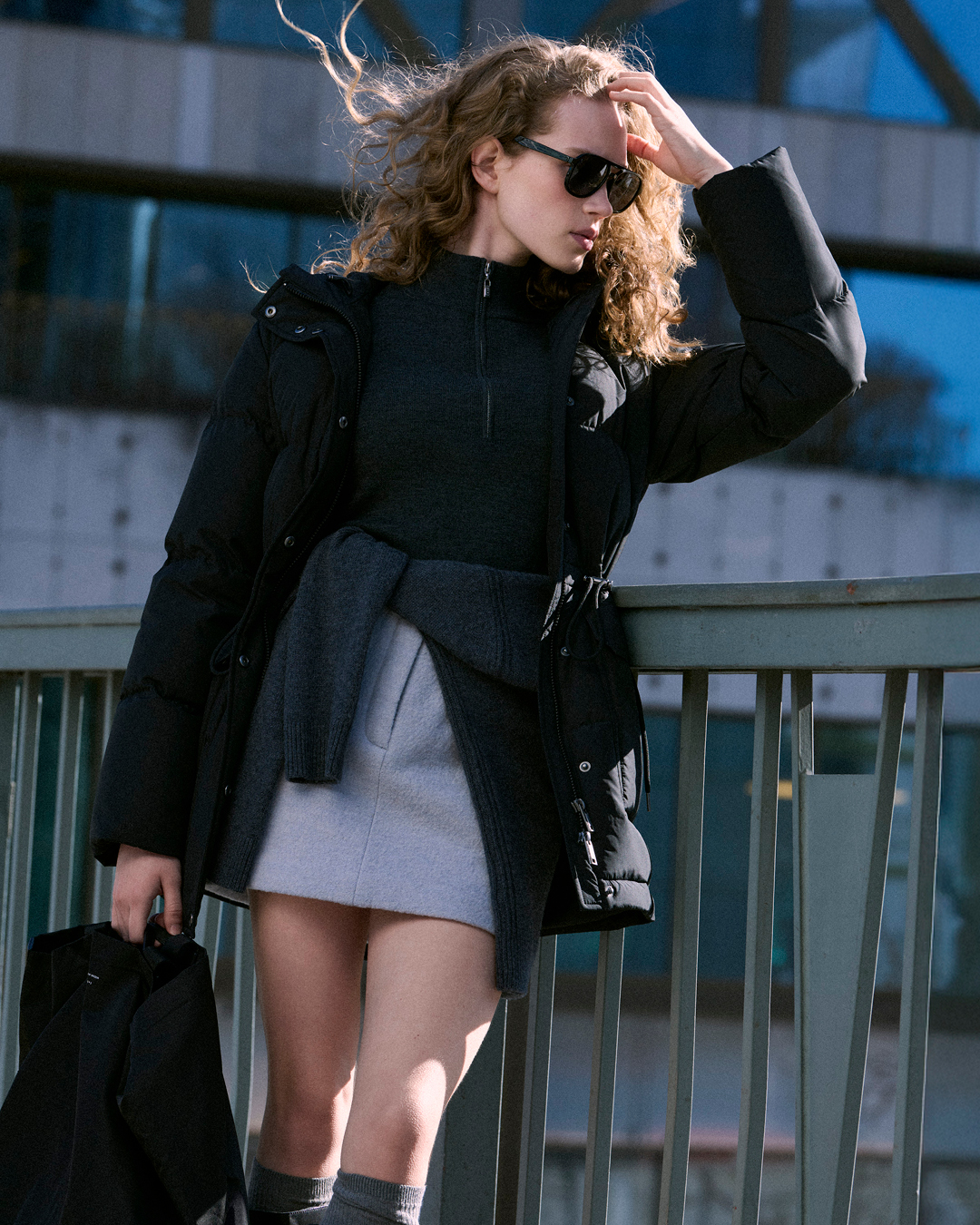 woman in puffer jacket and skirt