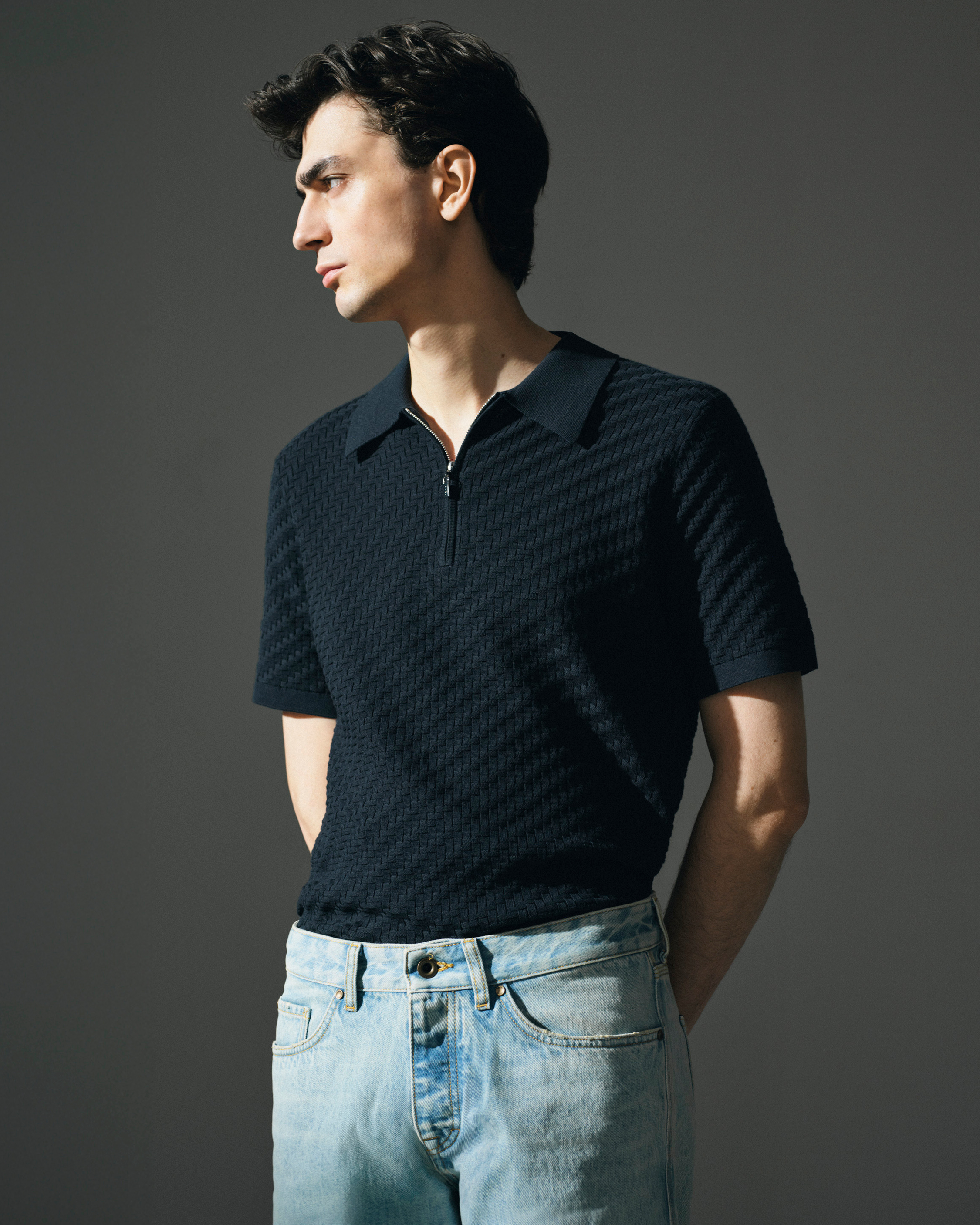 man in navy zip t-shirt & denim