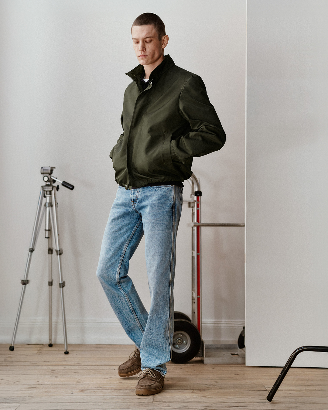 man in blue denim and green jacket